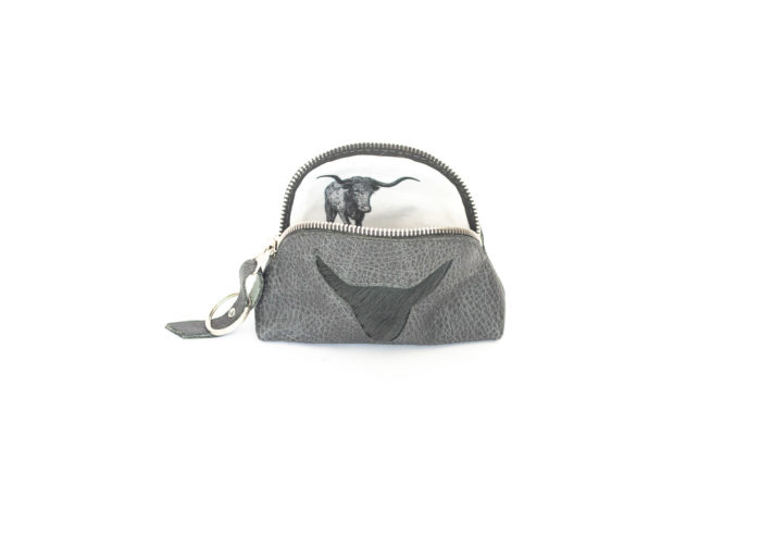 Image of the grey purse with a fur long horn cut out.