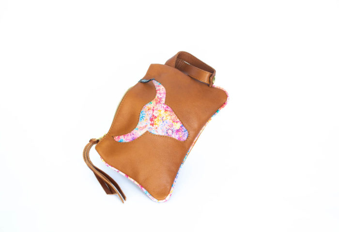 Picture of the front of the tan clutch with a pink flower longhorn on.