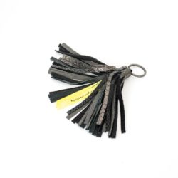 Tassel crafted with black leather in various textured finished with a golden keyring.